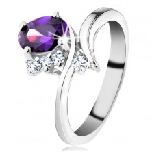 Prstan srebrne barve, ozki ukrivljeni kraki, vijoličast cirkonski oval